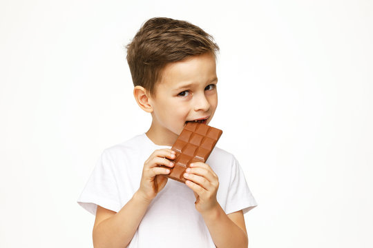 little beautiful boy holding chocolate studio shot 