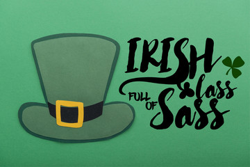 paper hat near irish lass full of sass lettering on green background