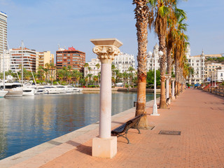 Beautiful promenade in Alicante. View of palm trees and port. Spain.