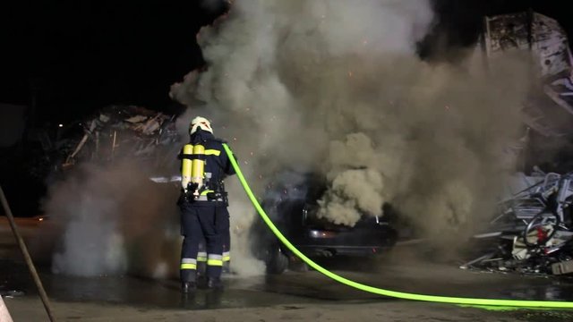 firefighter extinguish a huge carfire with huge flames