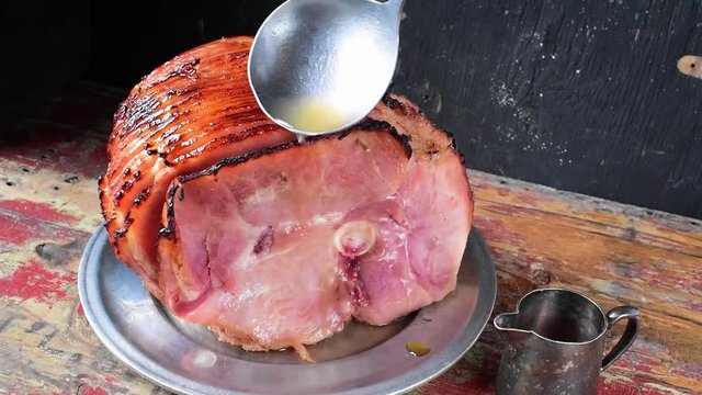 ladle juice over baked spiral cut ham