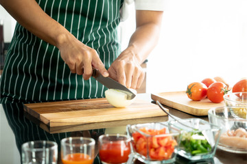 Hand of man holding knife cut vegetable preparing food for cooking, culinary concept, white background