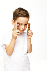 little beautiful boy holding chocolates studio shot 