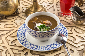 Thick dried mushroom soup with sour cream on oriental table