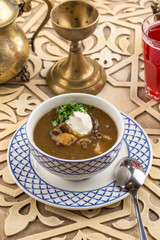 Thick dried mushroom soup with sour cream on oriental table