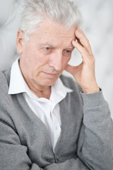 Close-up portrait of thoughtful senior man posing