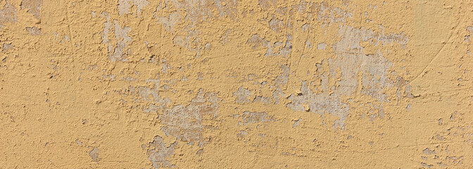 Beige yellow color, painted and faded wall texture grunge background