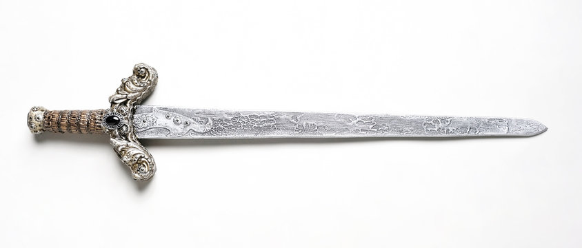 Closeup of vintage metal sword decorated with gems on white background