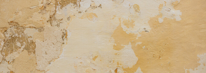 Beige yellow color, painted and faded wall texture grunge background
