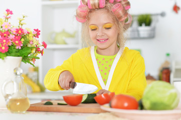 Portrait of cute little girl with hair curlers