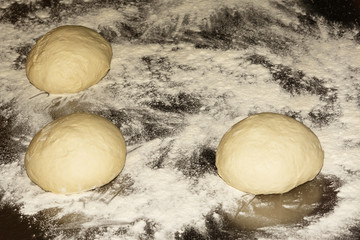 Fresh raw dough for pizza or bread baking on metal background. Close up. Selective focus.