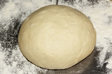 Fresh raw dough for pizza or bread baking on metal background. Close up. Selective focus.