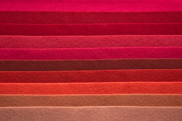  Fan of colored bright felt textile material. Brown, red,orange,purple, grey, yellow and pink color composition. Colorful felt texture for background with copy space. Felt fabric sheets