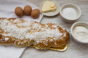 Braided bread, typical Easter dessert next to ingredients