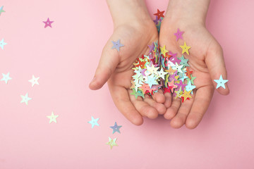 Gold glitter stars on children's hands.