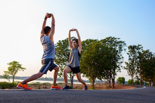 Running at sunrise couple exercising for marathon and workout .fitness, sport, people and lifestyle concept - Happy couples exercising with outdoor running