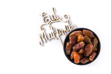 Dates and Eid Mubarak message isolated on white background. Top view