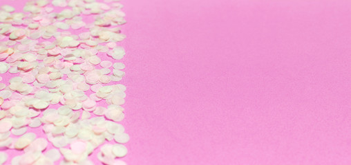 Flat lay paper round confetti on pastel pink background top view. Festive holiday background, concept of party, birthday, christmas or new year. Copyspace for text