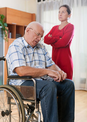 Fototapeta na wymiar wife next to elderly husband in wheelchair.
