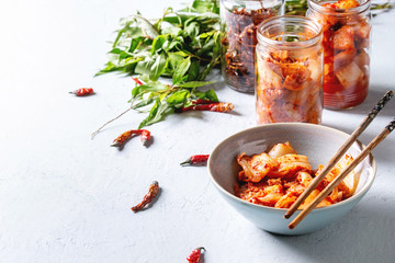 Korean traditional fermented appetizer kimchi cabbage and radish salad, hot spicy anchovies fish...