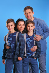 Portrait of happy family with twins look in camera and smiling