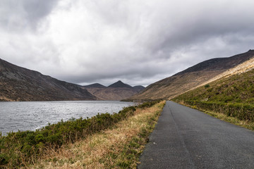 Fototapeta premium Road along a mountain lake