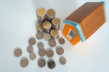 Small house and coin on black background