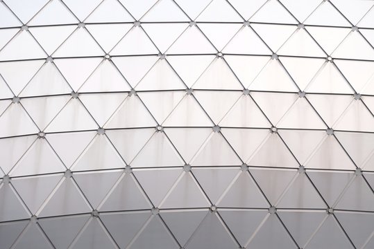 Close up a glass surface of a triangle pattern inside a high building in the city