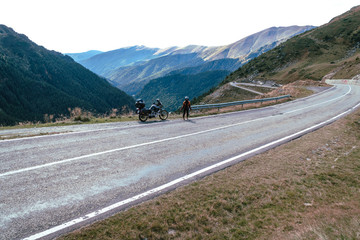 Fototapeta premium Woman with adventure motorcycle. Motorbike rider. Top of mountain road. Motorcyclists vacation. Travel and active lifestyle Transfagarasan Romaia, copy space