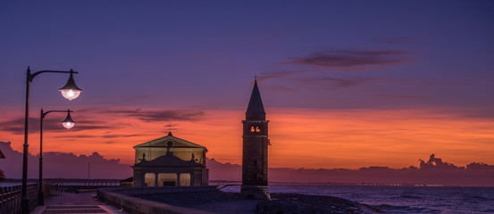 panorama of Caorle at sunset light of the street lamps lit. Size banner optimized