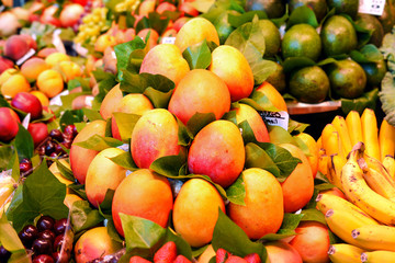 Fresh colorful tropical mango on display at farmers fruits market