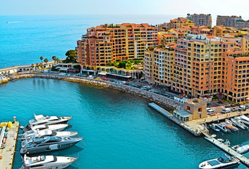 Fototapeta na wymiar Apartments and luxury yachts in the harbor of Monte Carlo, Monaco, Europe