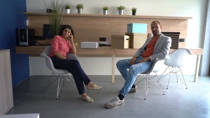 Portrait of happy, confident businessman and businesswoman at startup office - Powered by Adobe