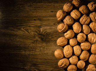 walnuts scattered on a wooden table