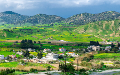 Fototapeta na wymiar Mountain landscape in North Cyprus. Small settlement at the foot of the mountains