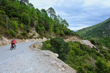 Fototapeta na wymiar Corsica-cyclist in the canyon river Golo