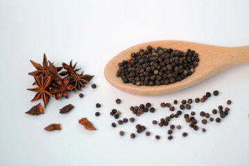 Spices in wooden spoon isolated on white background.