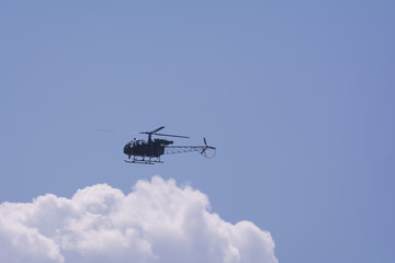 A small helicopter flying in the sky