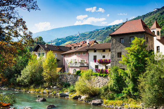 colorful houses along river Isarco (Eisack), Chiusa, Italy