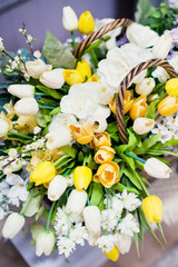 Fototapeta na wymiar yellow and white tulips in the basket