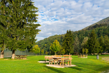 Obraz premium recreation field with picnic tables in spa town Levico Terme, Italy, near the lake