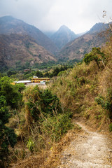Fototapeta na wymiar School in the valley of the village Jaibalito along lake Atitlan with misty mountains vertical, Guatemala