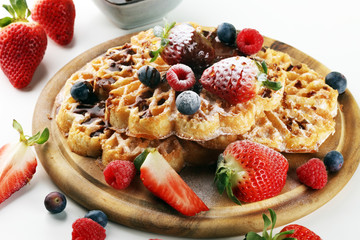 Waffle. Traditional belgian waffles with fresh fruit and powder sugar on wood