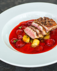 duck breast, vegetables, berry sauce and microgreen (main dish). food background. top view