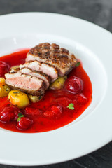 duck breast, vegetables, berry sauce and microgreen (main dish). food background. top view