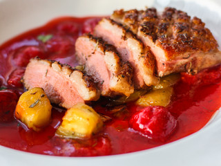 duck breast, vegetables, berry sauce and microgreen (main dish). food background. top view