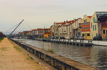 Fototapeta premium Aveiro, Portugal- December 31, 2015: Stunning landscape of city Aveiro, known as the Venice of Portugal. Colorful vintage buildings near city channel. Famous travel destination in Portugal