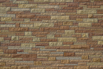 Attractive kasota limestone brick wall background with bricks in varying shades of brown