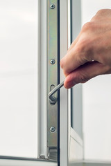 Workman adjusts the operation of the plastic window.