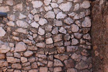 A wall of a rural mountain house made of stones